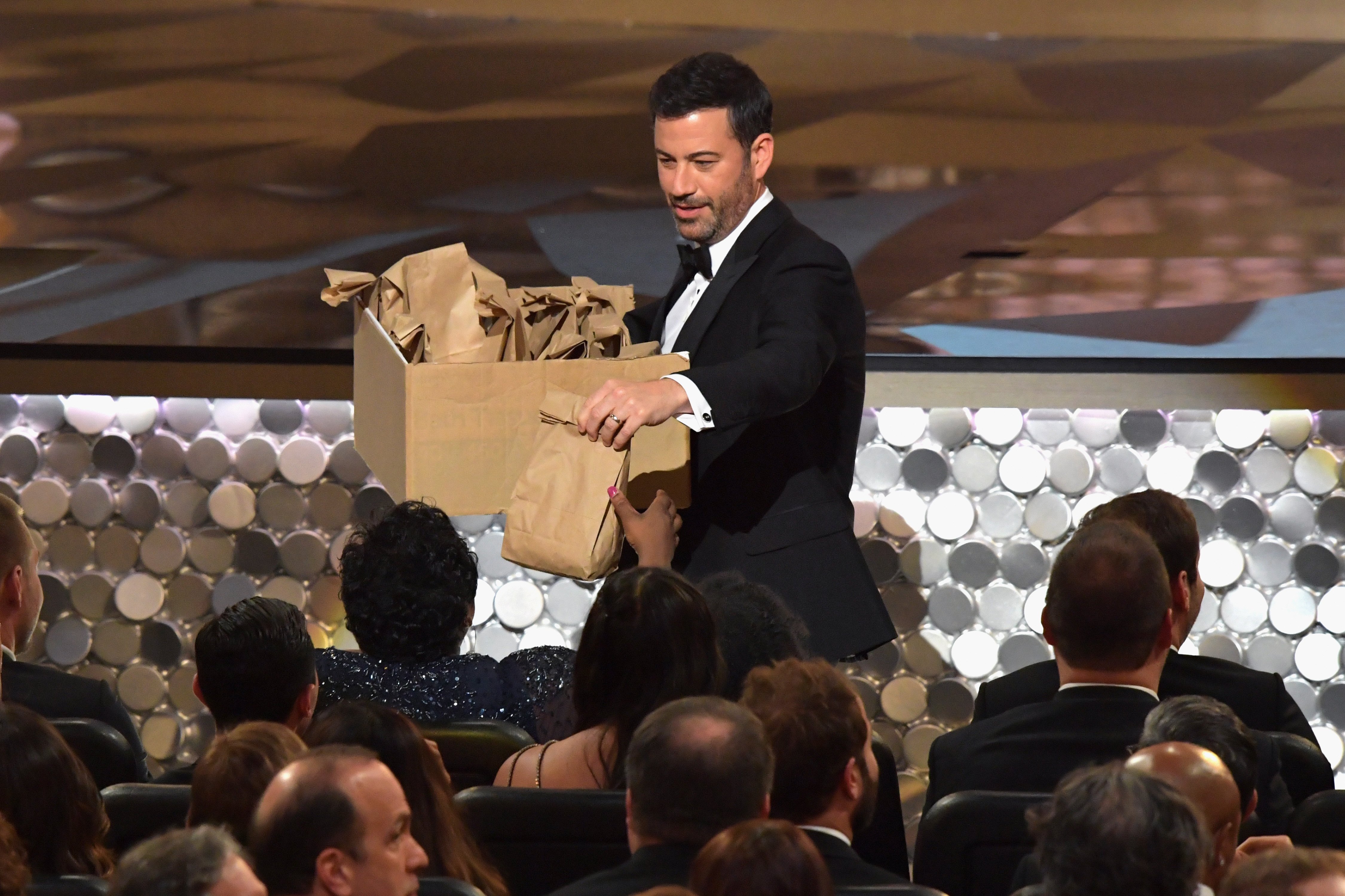 Host Jimmy Kimmel distributes snacks during the 68th Annual Primetime Emmy Awards at Microsoft Theater on September 18, 2016 in Los Angeles