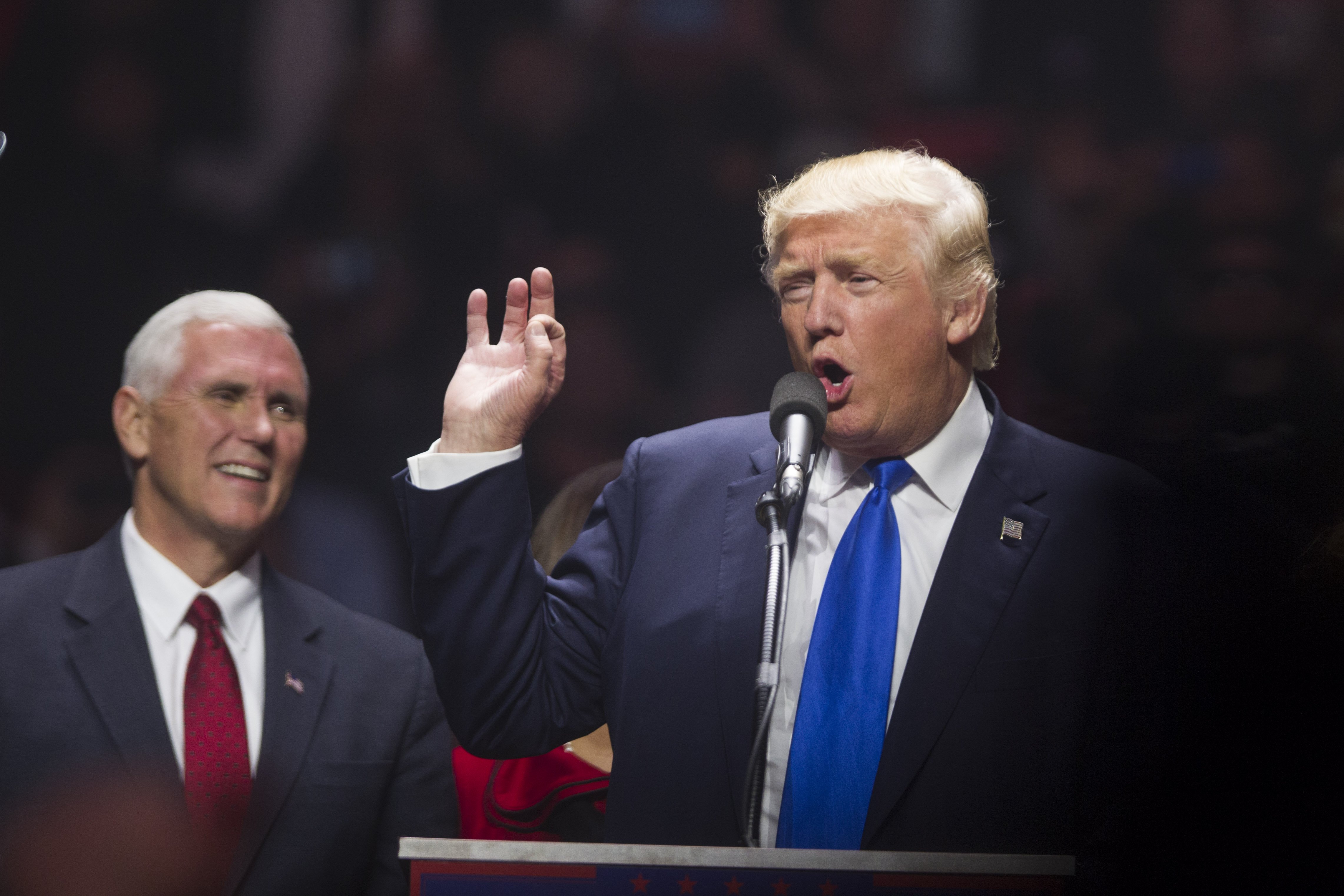 Donald Trump speaks on stage with running mate Indiana Governor Mike Pence during a rally at the SNHU Arena on November 7, 2016 in Manchester, New Hampshire.