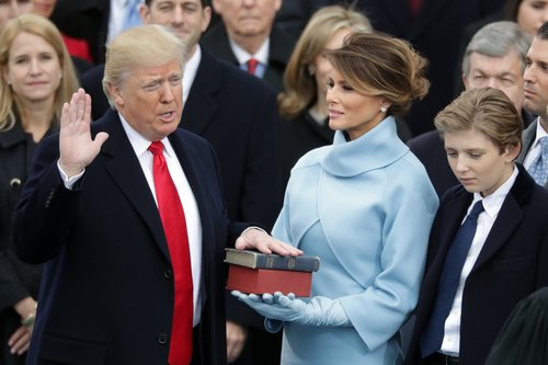 President Donald Trump takes the oath of office as his wife Melania Trump holds the bible and his son Barron Trump looks on, on the West Front of the U.S. Capitol on January 20, 2017 in Washington, DC