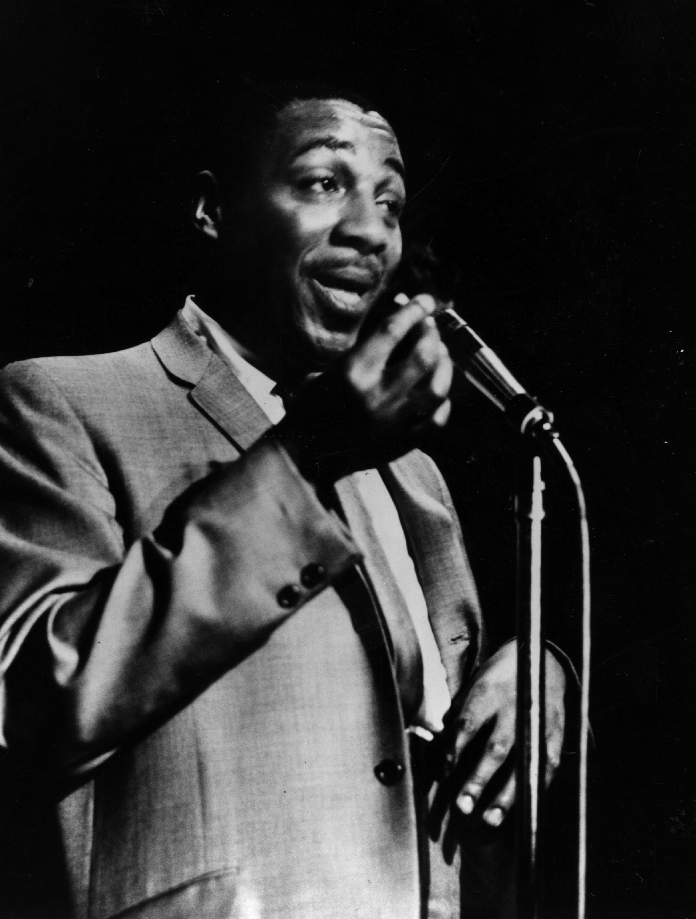 Comedian Dick Gregory at the microphone, 1962.