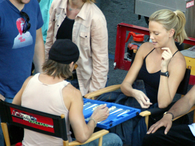 Charlize Theron playing backgammon on the set of The Italian Job.