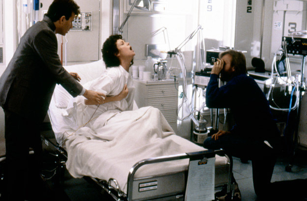 A behind-the-scenes shot of the film of Aliens with Sigourney Weaver, Paul Reiser, and director James Cameron.