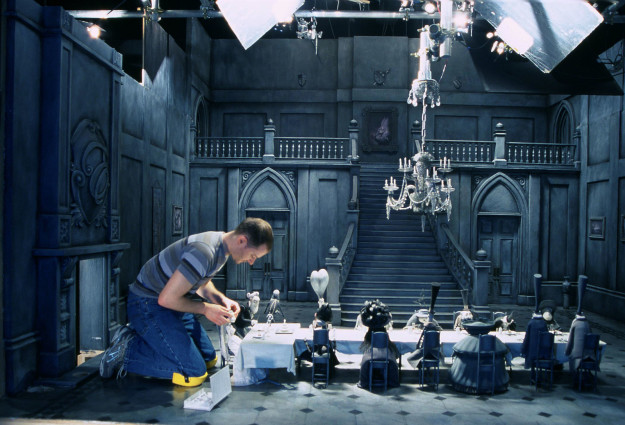 A prop artist dressing the miniature set of Tim Burton's The Corpse Bride.