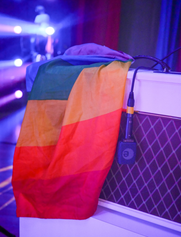 On the first night of my Rainbow tour, a fan threw a rainbow flag onto stage. Now, every night, I keep the flag on my hot pink Vox guitar amp until the end of the show — when I drape myself in it.