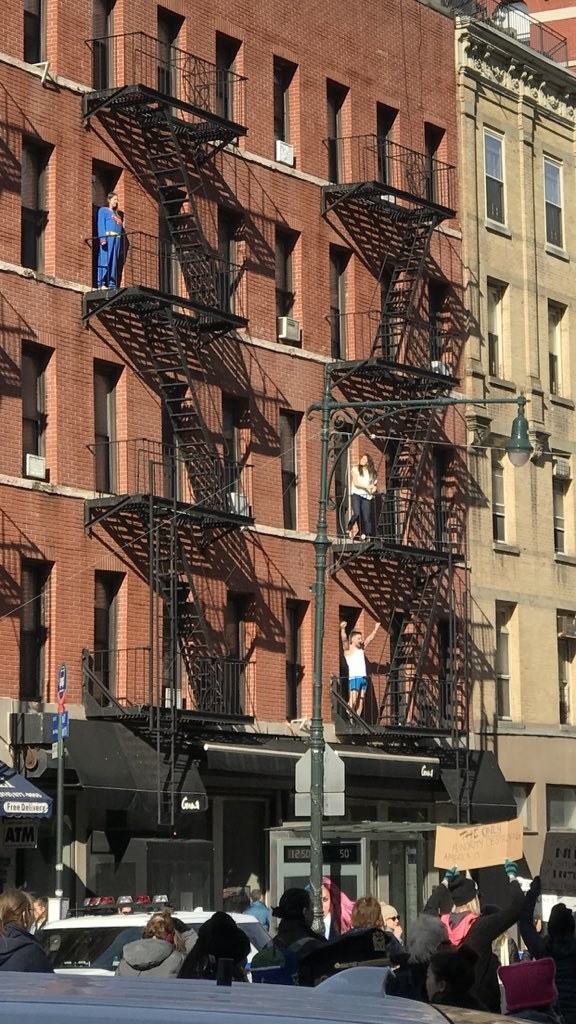 A guy on a balcony was wearing what looks like underwear and raising his arms in celebration as he thought the crowd was cheering him on.