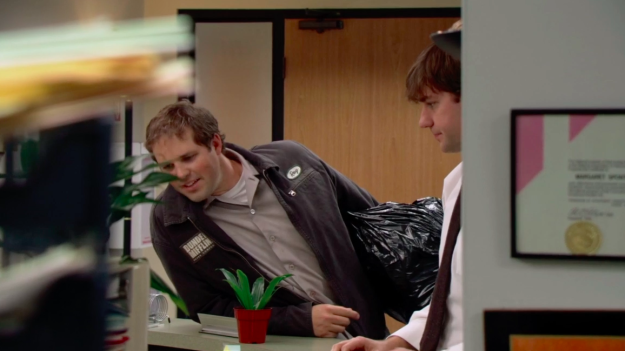 The way the shot is framed, we see Jim and Pam being flirty at the reception desk, and then Roy walks into the office and comes between them. It's our very first glimpse at this love triangle in action. Symbolic AF!!!